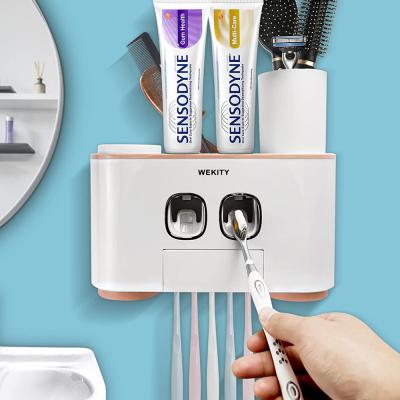 Wekity Toothbrush Holder Multifunctional Wall Mounted Space Saving Toothbrush and Toothpaste Squeezer Kit with Dustproof Cover 5 Toothbrush Slots 2 Automatic Toothpaste Dispenser and 4 Cups Pink